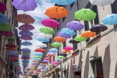 Pietrasanta, Lucca: the main street with colorful umbrellas